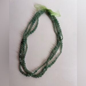 Triple-strand green glass bead necklace